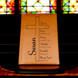 Personalized tan leatherette journal with custom name Susan, large cross design, and Proverbs 31/Romans 8 Bible verses – beautiful Christian women's gift on colorful stained glass background