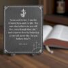 slate engraved scripute plaque with john 11:25 26 on it sitting on a table with candle
