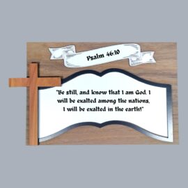 Close-up of Psalm 46:10 plaque showing blue acrylic inlay, wooden cross accent, and elegant banner design