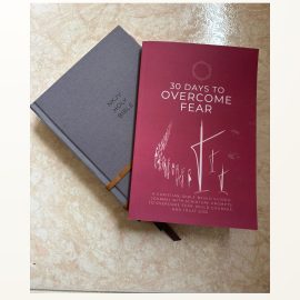 Bible and OVercoming Fear journal next to each other