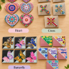 Colorful diamond art corner bookmarks displayed on a light oak surface in four styles: Heart, Cross, Butterfly, and Faith & Encouragement, featuring sparkling designs and inspirational messages.